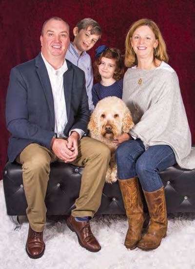 Jim and Melissa Kubu with Hank the goldendoodle and their two human children, Jamison and Olivia.